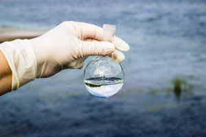 Samples of water from the river. Water intake. Water abstraction. Water diversion. Environmental pollution.